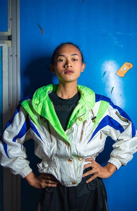 A Gay Asian Man Posing In A Tracksuit In Front Of A Blue Locker Stock Photo Image Of