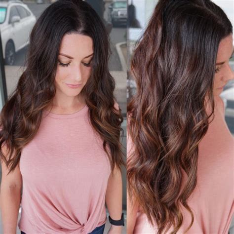 Long Brunette Wavy Layered Cut With Warm Toned Highlights The Latest Hairstyles For Men And