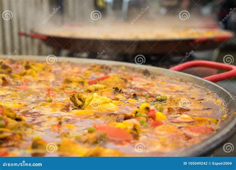 The Cooking Process of Paella in a Huge Frying Pan. Stock Photo - Image ...