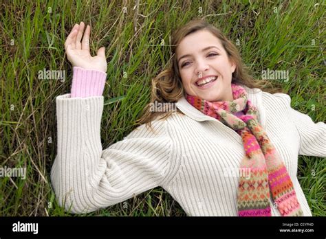 Female Long Blonde Hair Wearing Cream Zip Up Jumper Over Pink Jumper Pink Patterned Wool Scarf