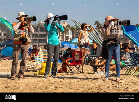 Male And Female Asian American Amateur Photographers Focus On A July Fourth Air Show In