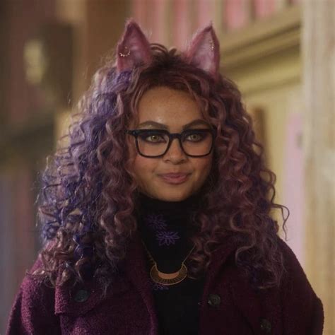 A Woman With Long Curly Hair And Cat Ears On Her Head Wearing Glasses