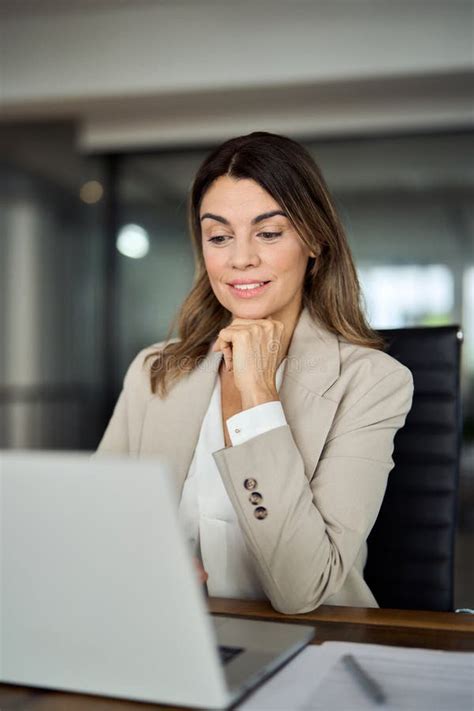 Busy Mature Professional Business Woman Looking At Laptop Working In