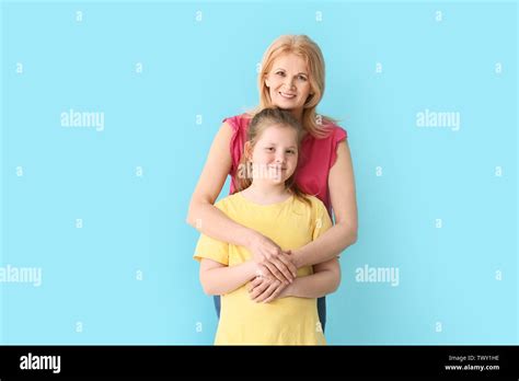 Mature Woman And Her Cute Granddaughter On Color Background Stock Photo Alamy