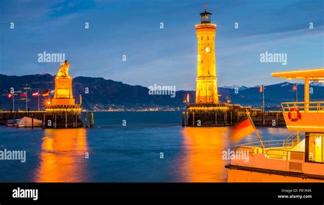 Harbor With Lighthouse And Bavarian Lion At Dusk Lindau Lake