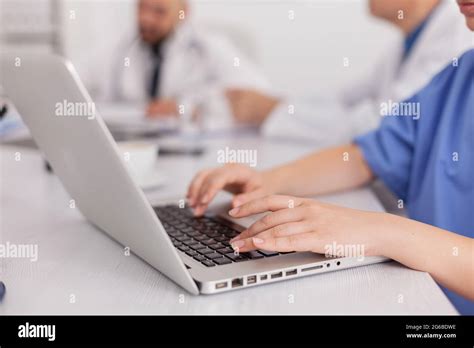 Close Up Of Practitioner Woman Nurse Hand Typing Sickness Treatment On