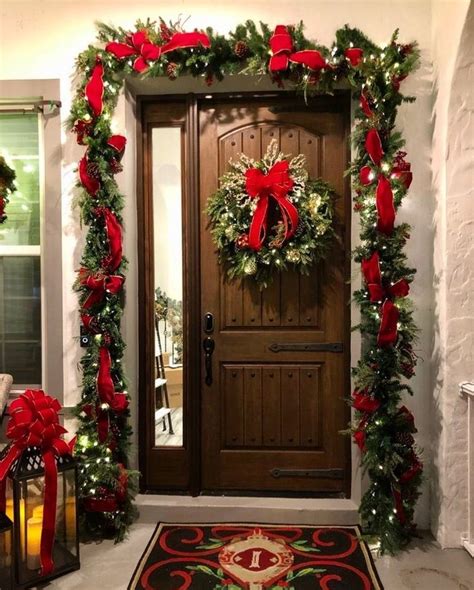 A Door Decorated With Christmas Wreaths And Red Bows