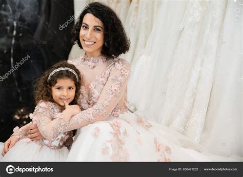 Brunette Middle Eastern Woman Wavy Hair Embracing Cute Girl Smiling Stock Photo