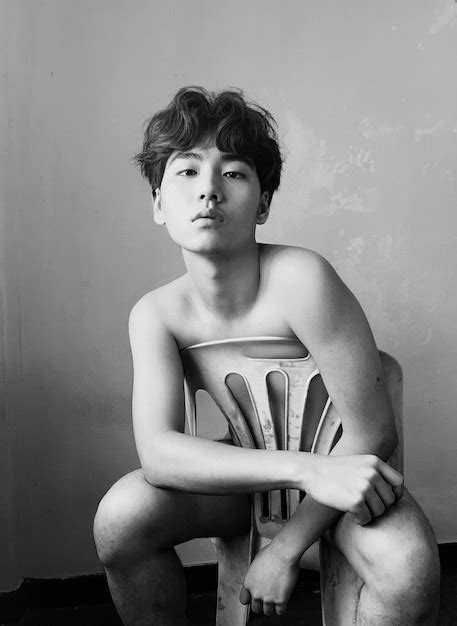Premium Photo Portrait Of Naked Man Sitting On Chair Against Wall