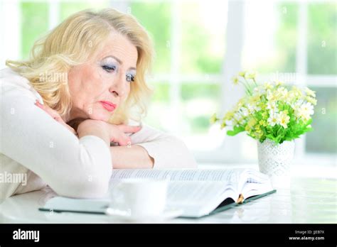 Mature Woman Reading Book Stock Photo Alamy