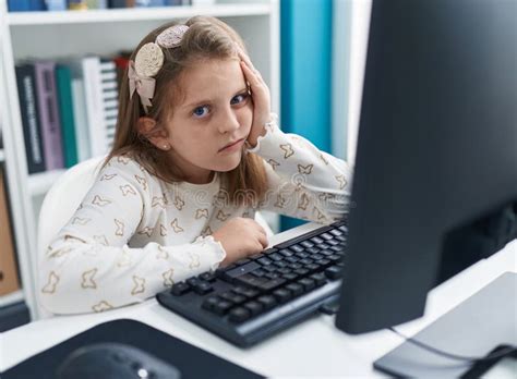 Adorable Blonde Girl Student Tired Using Computer At Classroom Stock Photo Image Of Caucasian