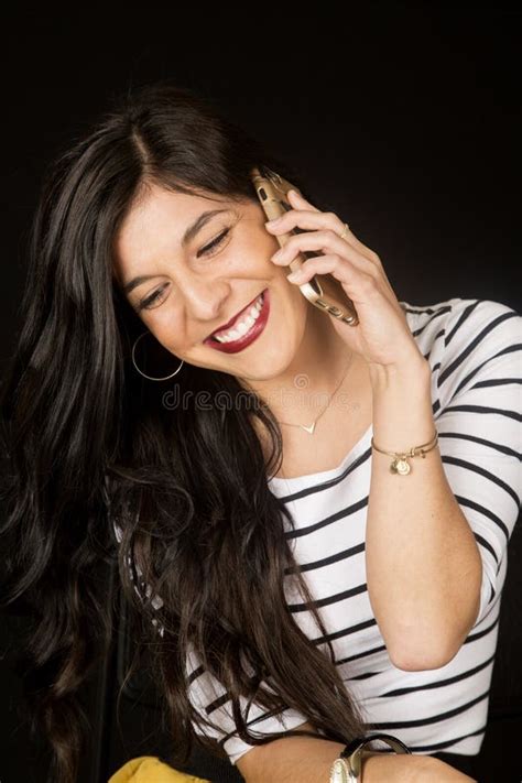 Happy Brunette Woman Talking On Her Cell Phone Smiling Looking D Stock