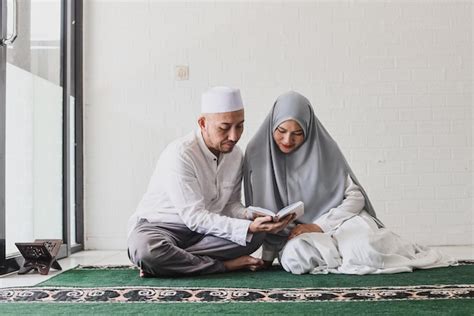 Premium Photo Asian Muslim Man Teaching His Wife Reading Koran Or