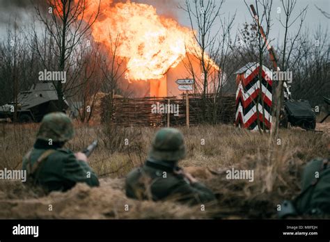 German soldiers Wehrmacht in a trench in the background of a burning ...