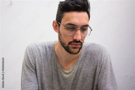 Sad man looking down with pensive expression Stock Photo | Adobe Stock