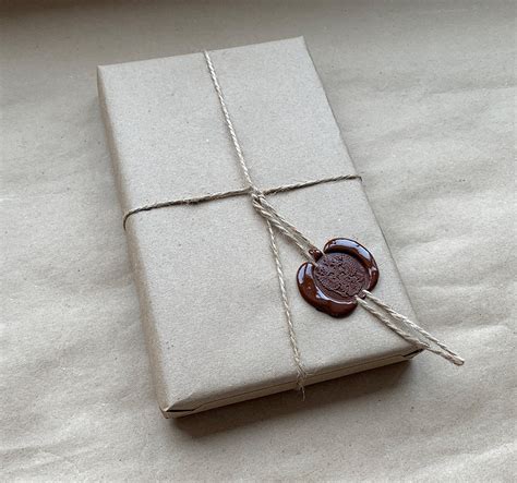 Упаковка подарка в бумагу крафт с нанесением сургучной печати