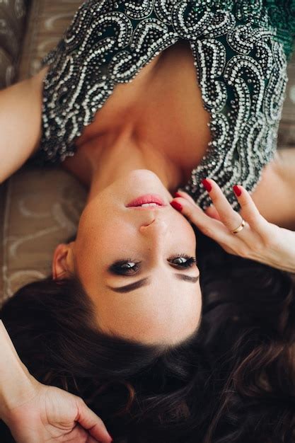 Free Photo Above View Of Beautiful Brunette Woman With Perfect Volumed Hair Lying On Back