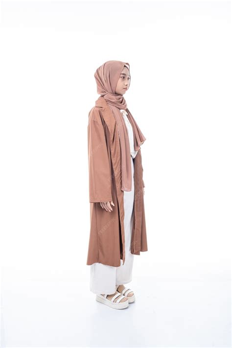 Premium Photo A Woman Wearing A Brown Hijab With A White Shirt And