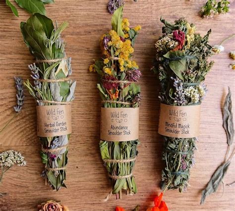 Three Bundles Of Wildflowers Tied To Twine On A Wooden Table With