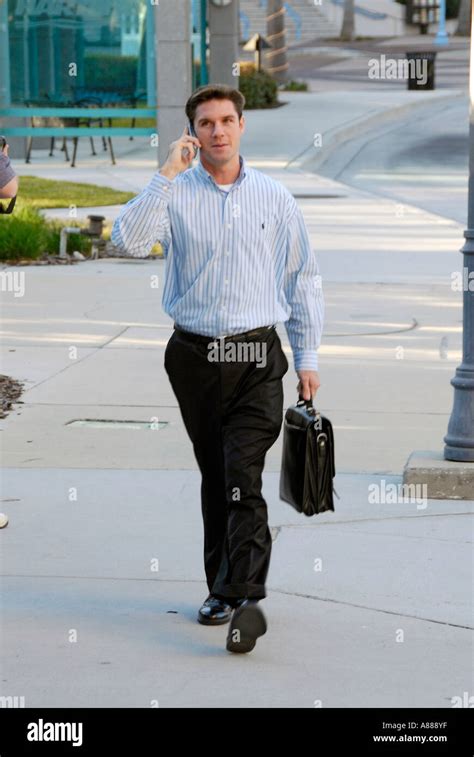 Professional Man Walking With Laptop Computer While Talking On A