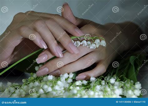 Woman Nails Manicure With Flowers Nails Covered With Nude Nail Polish