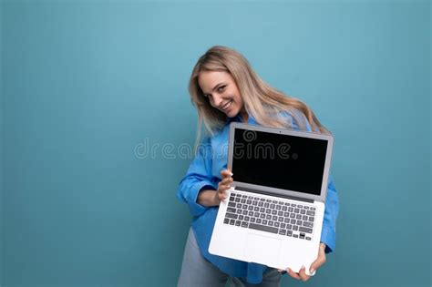 Happy Lucky Blonde Girl Demonstrates Laptop Screen Blank Space For Web Page On Blue Background