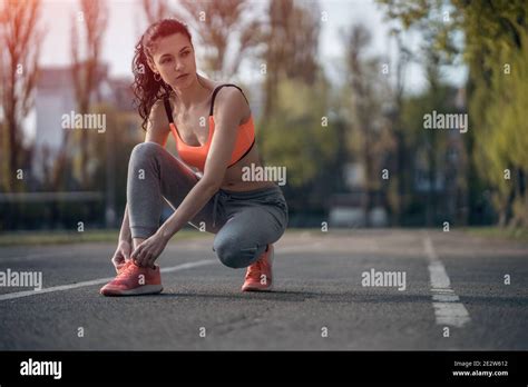 Attractive Brunette Woman Warm Up And Stretching In Park At Sunshine Stock Photo Alamy