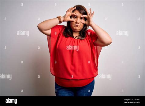 Beautiful Brunette Plus Size Woman Wearing Casual Red T Shirt Over Isolated White Background