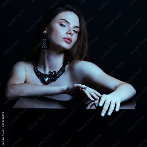 Beautiful And Sexy Looking Brunette Woman With Fancy Black Earrings And Necklace With Gemstones