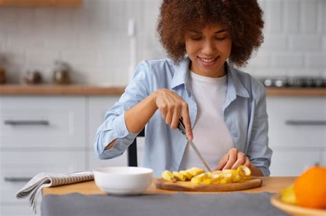 Free Photo Front View Woman Cutting Banana