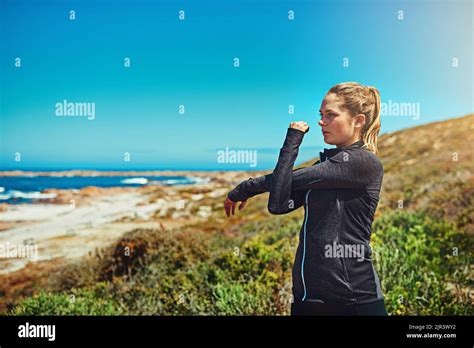 Stretch, exercise, run then relax. a sporty young woman stretching ...