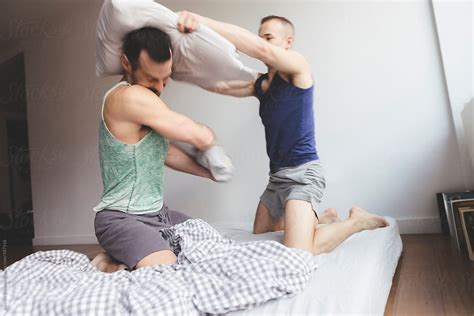 Gay Jock Lovers Playfully Horsing Around In Bed Having A Pillow Fight By Stocksy Contributor
