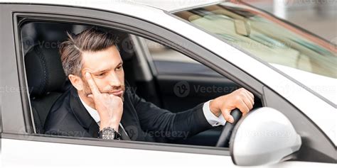 Hopeless middle-aged businessman touching his forehead while driving