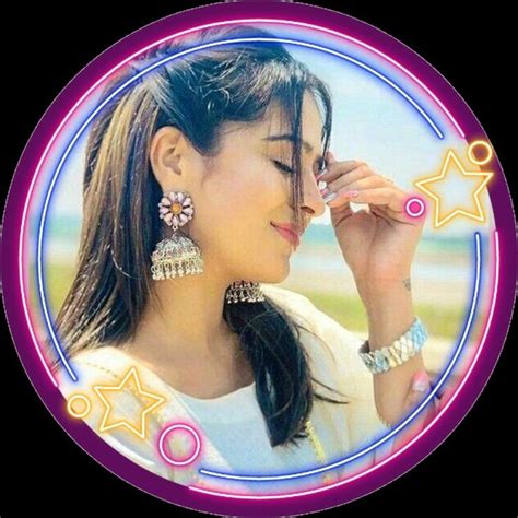 A Woman Talking On A Cell Phone In Front Of A Circular Frame With Stars