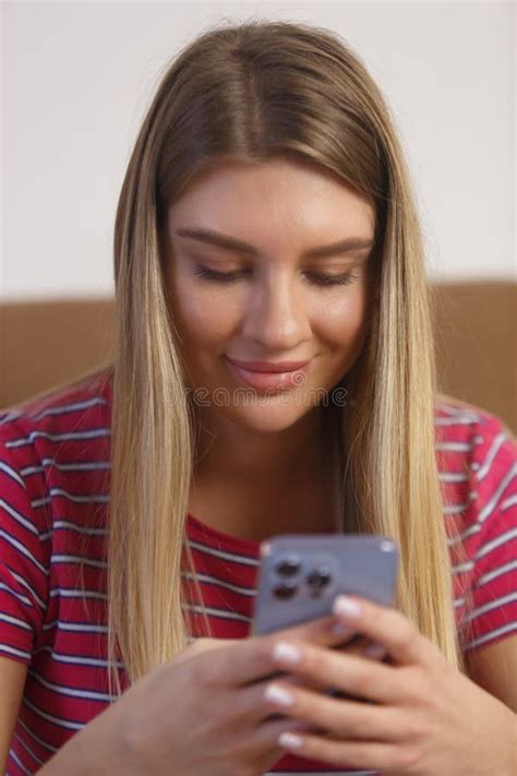 Portrait Of Beautiful Blonde Girl Typing A Message On Mobile Phone Cheerful Ukrainian Female