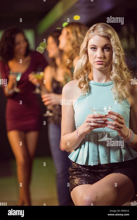 Blonde Woman Drinking Cocktail Stock Photo Alamy