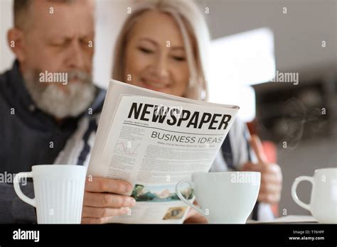 Mature Couple Reading Newspaper At Home Stock Photo Alamy