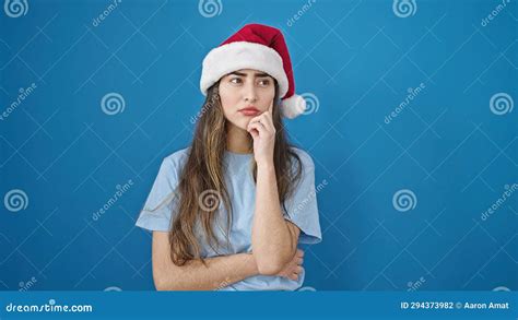 Young Beautiful Hispanic Woman Wearing Christmas Hat With Doubt