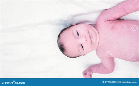 Hairy Brunette Cute Newborn Baby Lying On Back On White Sheet Naked Moon Baby Half Body Shot