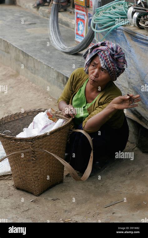 Tribal Woman Smoking Cigar On The Vegetable Market In Ruma Bazaar