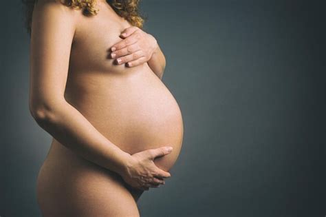 Premium Photo Midsection Of Naked Pregnant Woman Standing Against Gray Background