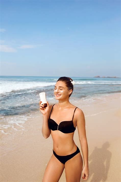 Beautiful Woman In Bikini Applying Sun Cream On Tanned Shoulder Sun