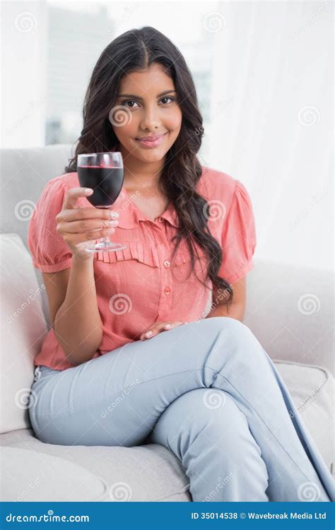 Content Cute Brunette Sitting On Couch Holding Wine Glass Stock Photo Image Of Person Front