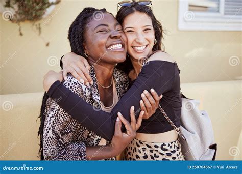 Two Girls Hugging On Sidewalk Feeling Joyful And Happy Together