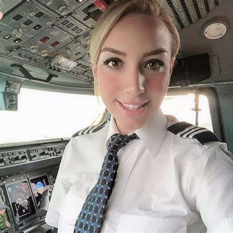 A Female Pilot Is Smiling For The Camera