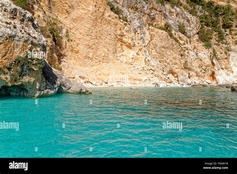 Cala Dei Gabbiani A Narrow Sandy Beach Below High Limestone Cliffs