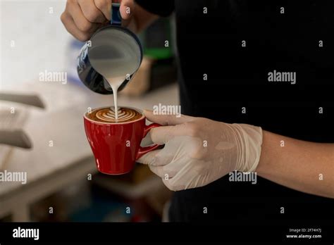 Close Up Barista Pouring Steamed Milk Into Coffee Cup Making Beautiful