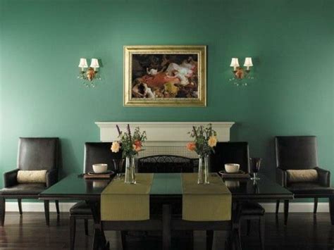 A Dining Room With Green Walls And Chairs