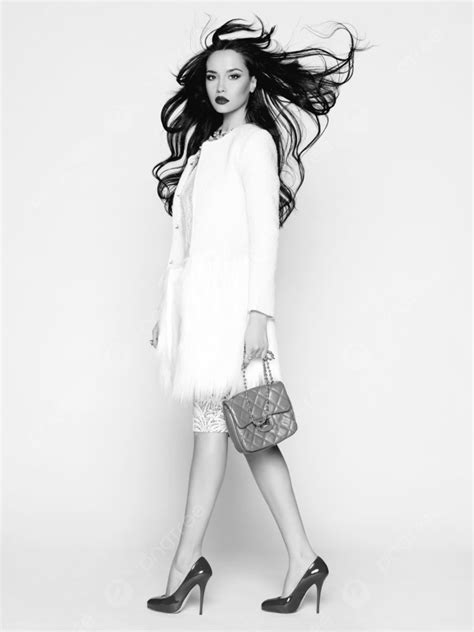 Beautiful Brunette Model In Fashion Clothes Posing In Studio Black And White Photo Background