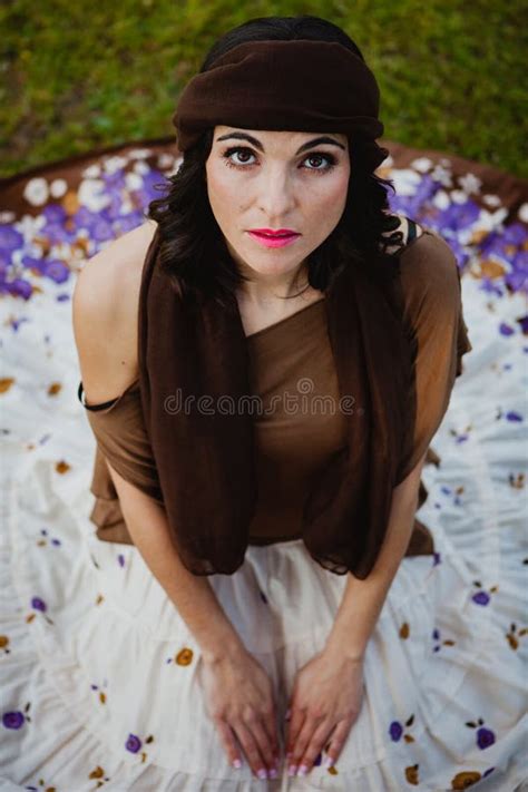 Pretty Brunette Woman Sitting With A Flowered Skirt View From A Stock Photo Image Of Outdoor